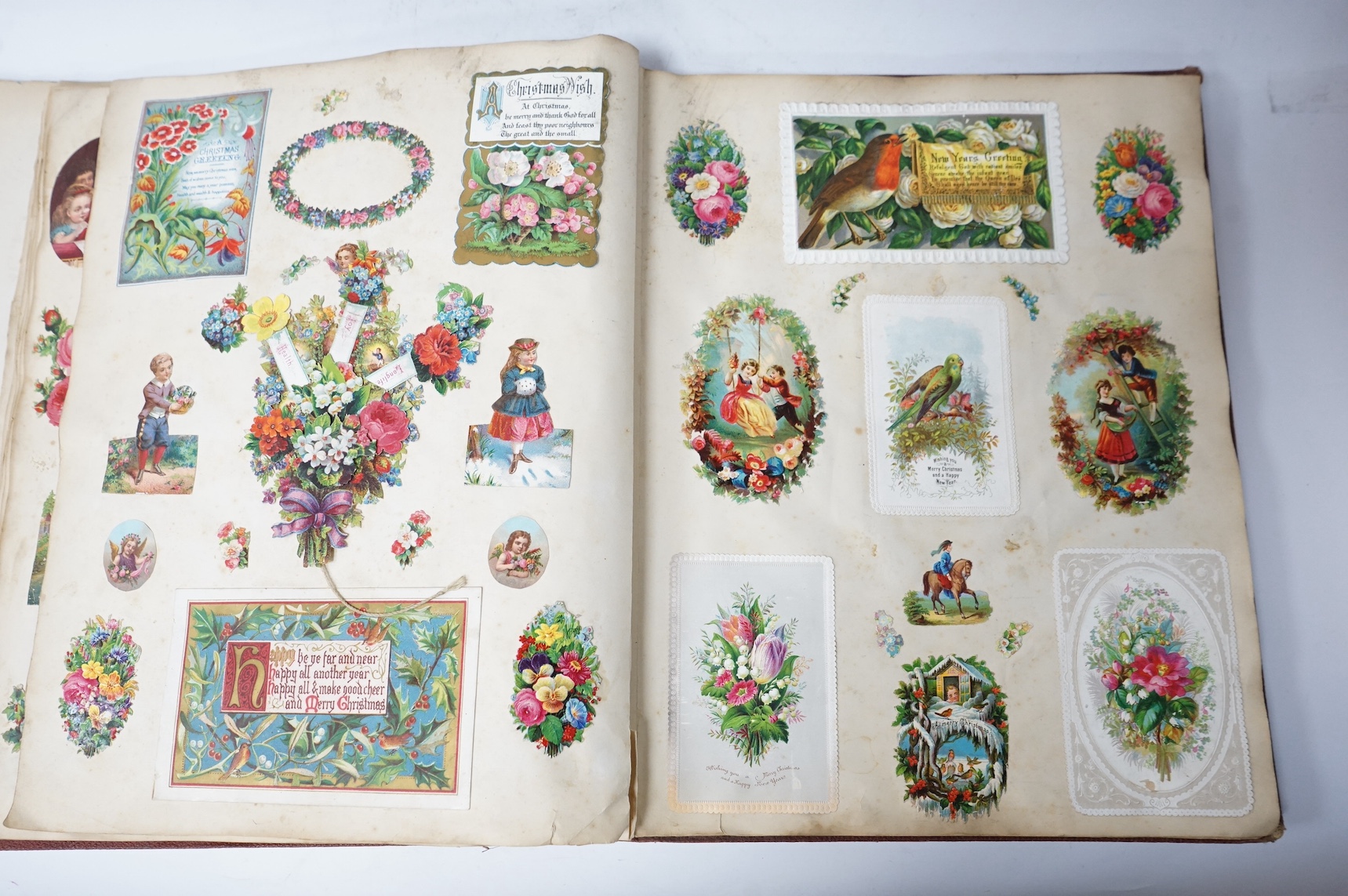 A Victorian album of greetings cards and decoupage. Condition - good